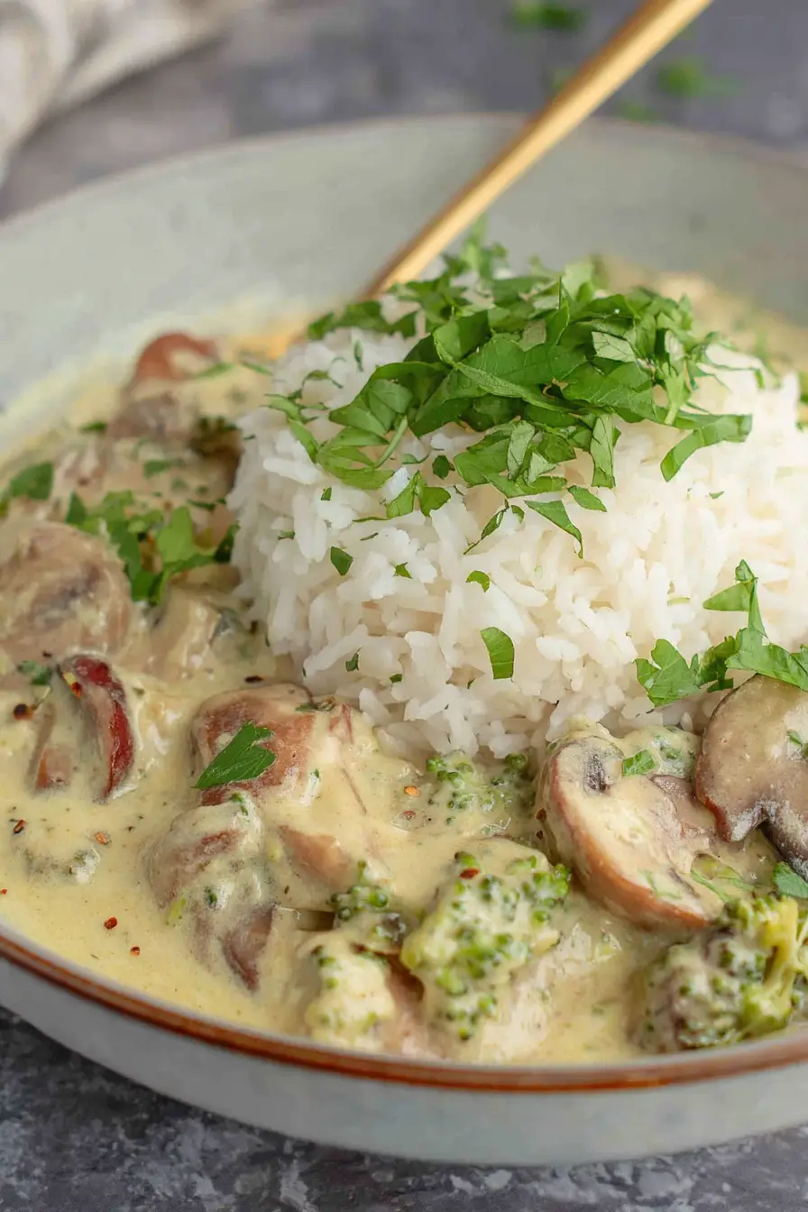 Creamy mushroom gravy with rice and parsley garnish